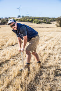 Agronomist soil testing in paddock